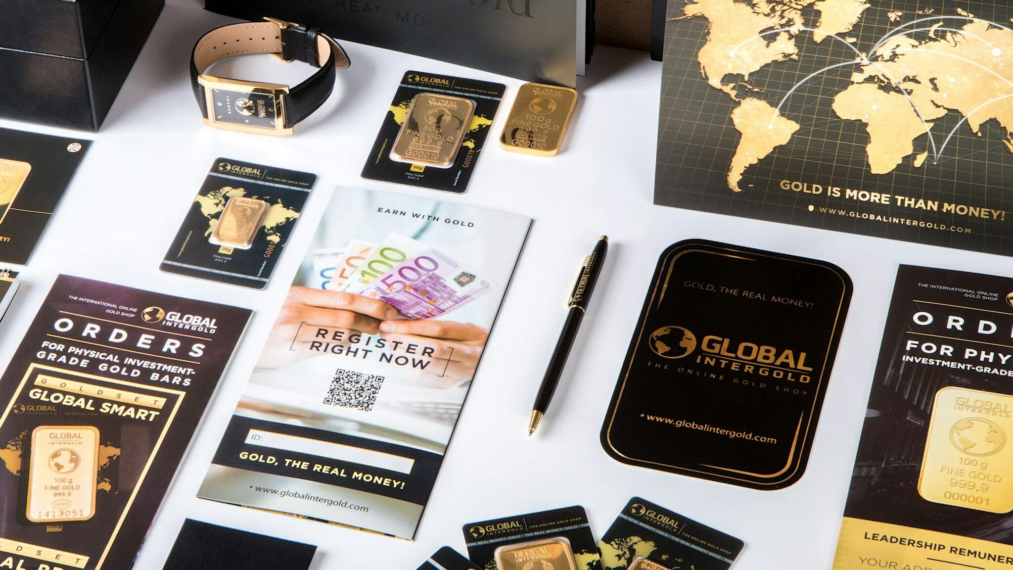 Flat lay of promotional materials for gold investment, featuring brochures, cards, and gold bars.